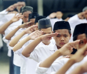 Students line up for morning exercises and salute allegiance to Islam and to their Islamic teacher.
