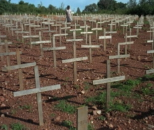 A young girl walks through Nyaza cemetery outside Kigali, Rwanda, on November 25, 1996. Thousands of victims of the 1994 genocide are buried there.