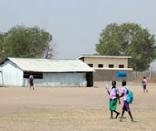 Before Bor B Primary School built latrines on the school grounds (pictured in background), students would leave during their break and not return.