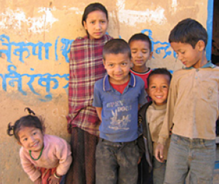 Children in the Rolpa district in western Nepal, a Maoist stronghold. Behind the children is a slogan calling for the overthrow of the royal government.