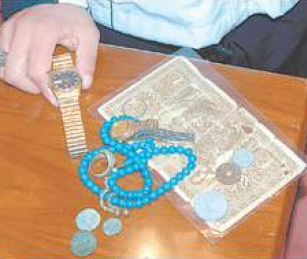 Muhammad Haidar displays some belongings of his father, a