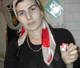 Imani Soltukhanova holds a photo of her husband, slain human rights activist Aslan Davletukaev