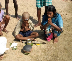 Recently widowed Gourakka and her son,Ganesh, 6, conduct a religious ceremony in memory of her husband.