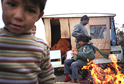 Photo: A family around their campfire in the Roma settlement of Vaulx-en-Velin France
