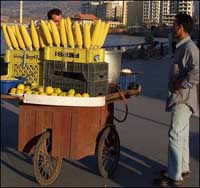 Photo: vendors sell corn on the cob.