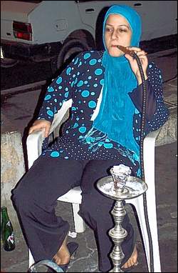 Photo: A woman smokes tobacco.